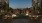 a patio with tables and chairs at dusk