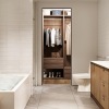 a bathroom with a tub sink and mirror